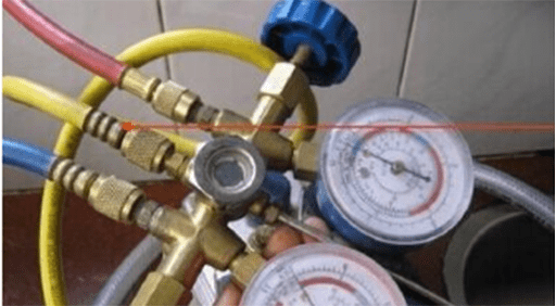 a worker handing a three-colour tube and meters